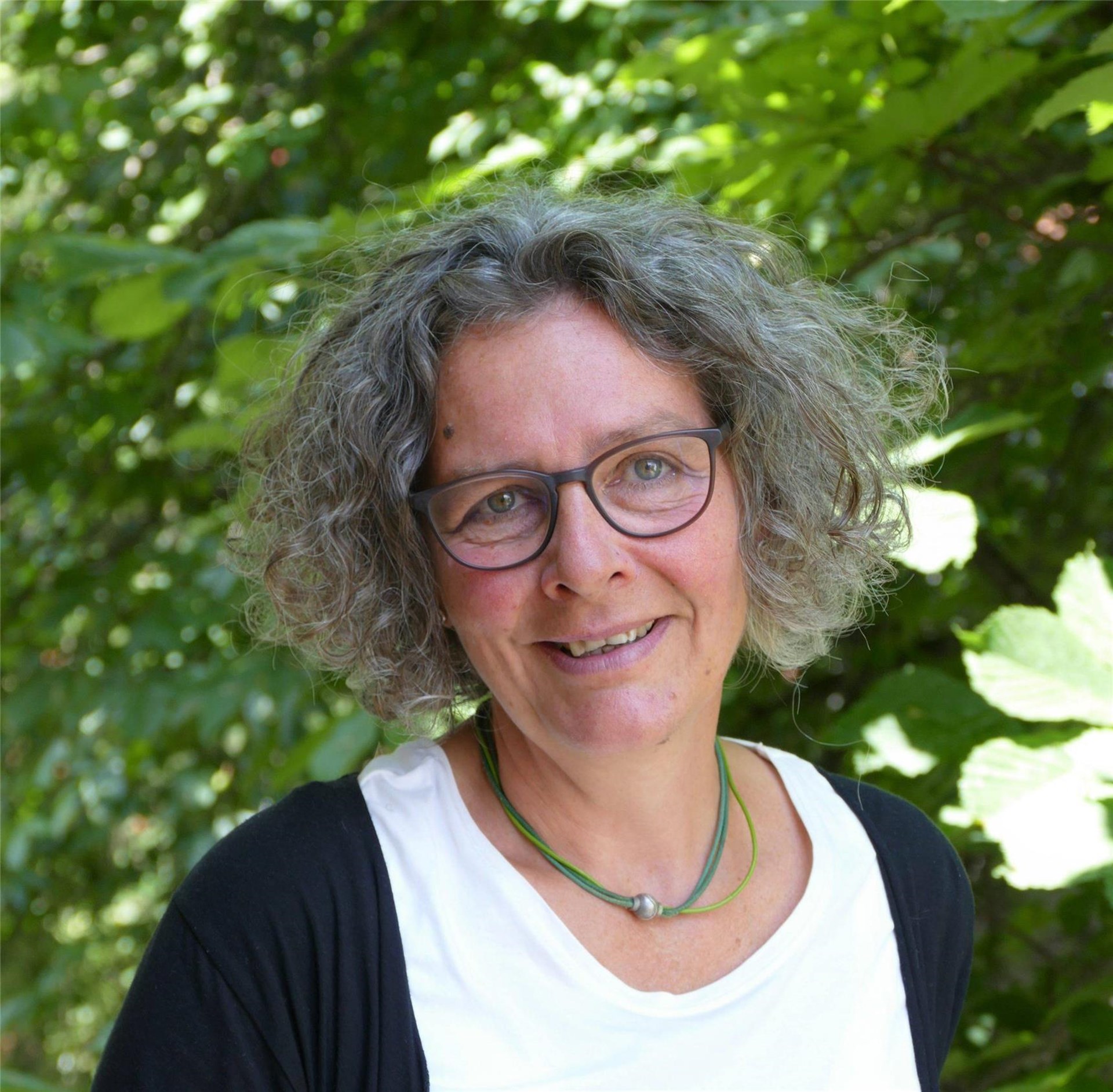 Portraitbild einer Frau mit kinnlangen grauen Haaren.